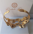 bracciale rigido aperto a fascia di Rachele Falvo in bronzo placcato oro con cristalli grezzi di ametista viola naturale