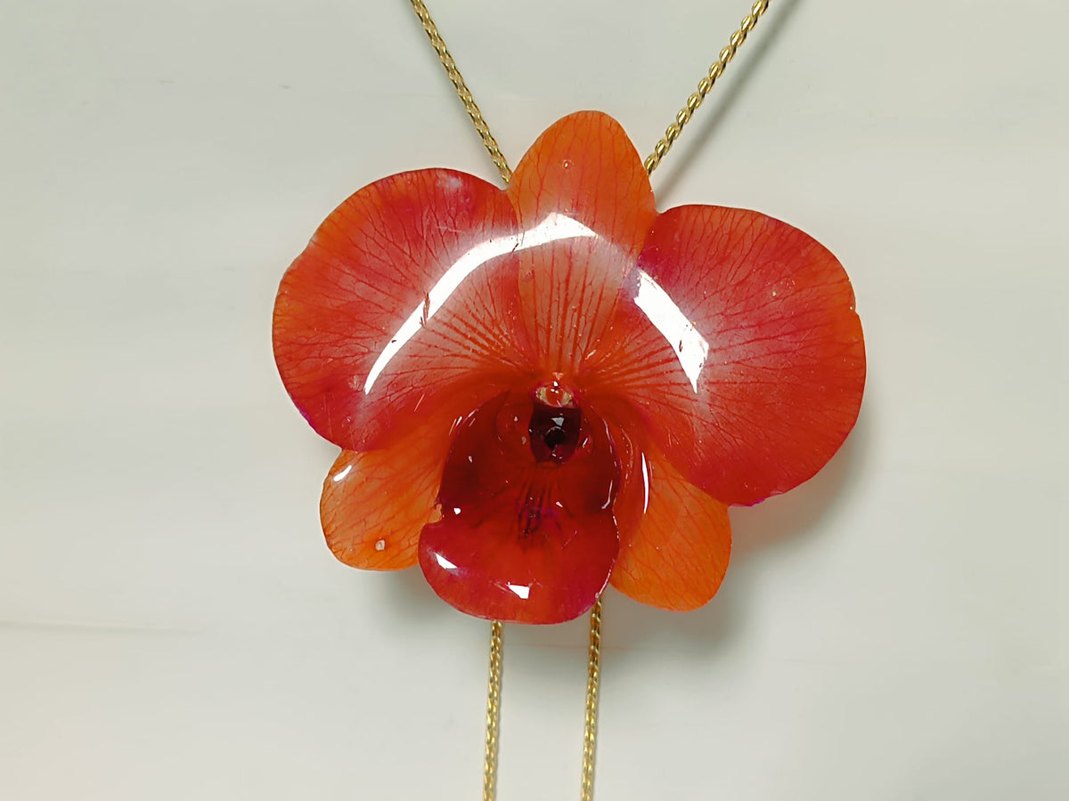 Collana saliscendi con vera orchidea arancione in resina