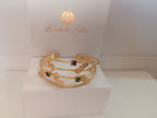 bracciale cuff a quattro fili dorati di Rachele Falvo con topazi naturali a taglio quadrato e elementi astratti lucidi