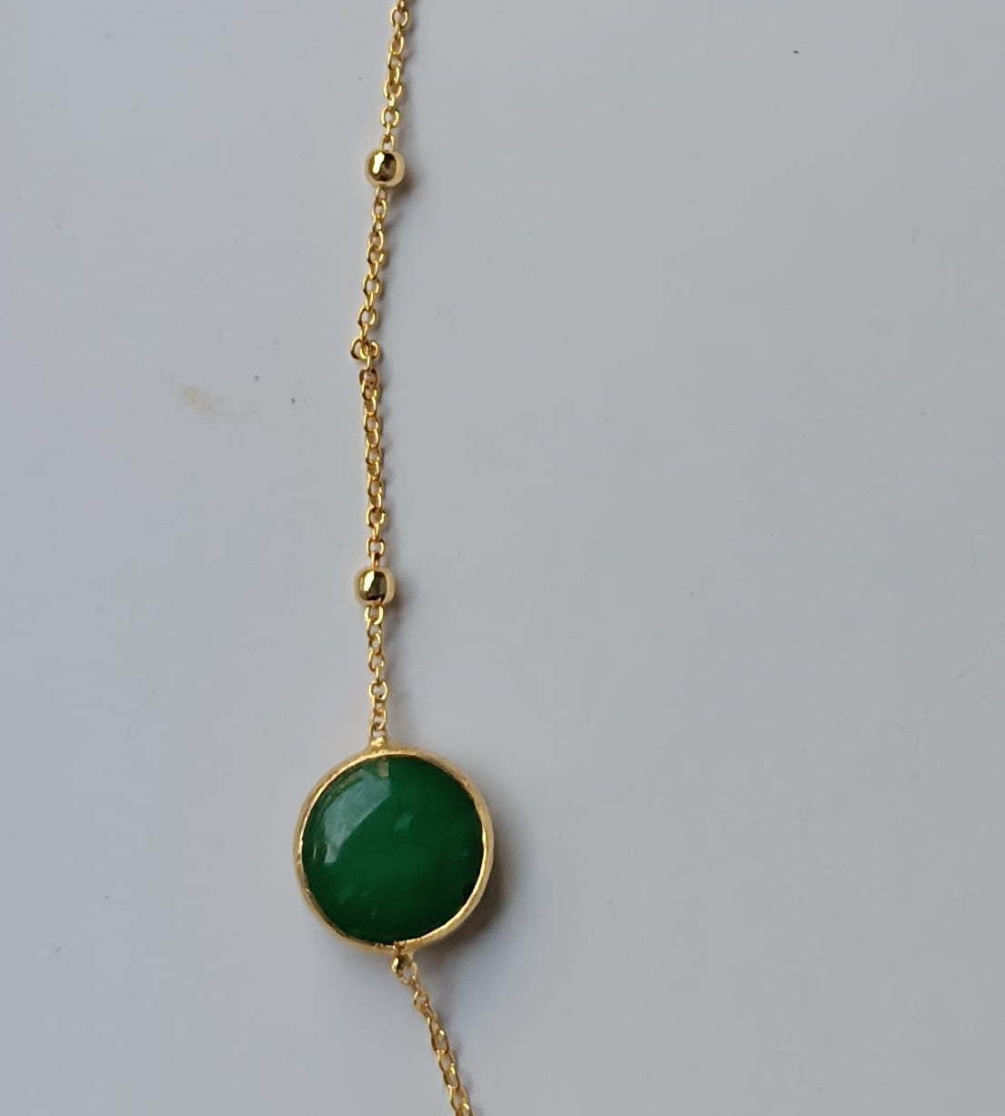 Collana lunga sautoir da 90 cm in bronzo dorato con pietre di giada verde naturale incastonate e sferette dorate lungo la catena