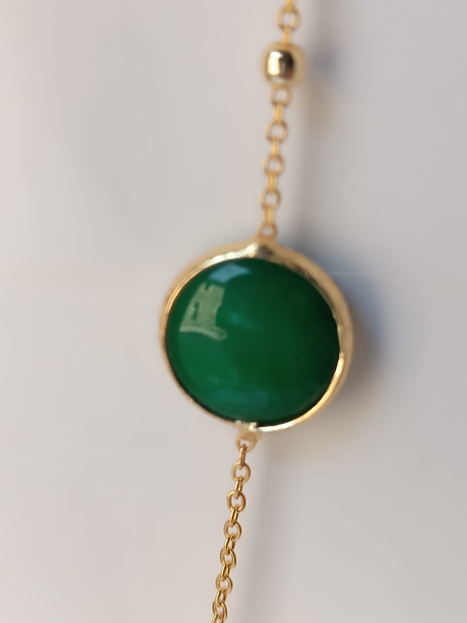 Collana lunga sautoir da 90 cm in bronzo dorato con pietre di giada verde naturale incastonate e sferette dorate lungo la catena
