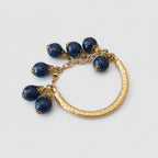 Bracciale in oro opaco su bronzo con sei topazi azzurri tondi sfaccettati regolabile