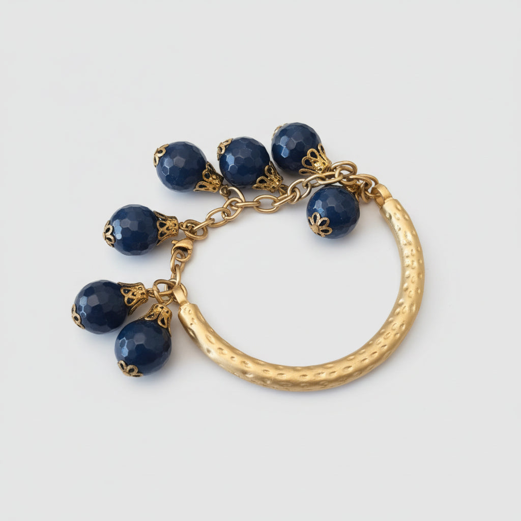 Bracciale in oro opaco su bronzo con sei topazi azzurri tondi sfaccettati regolabile