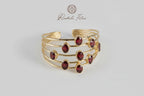 Bracciale cinque fili in oro su bronzo martellato con nove granati rossi naturali regolabile
