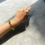 Bracciale etrusco a molla in bronzo con oro opaco e topazi azzurri naturali
