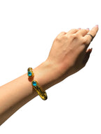 Bracciale etrusco a molla in bronzo con oro opaco e topazi azzurri naturali