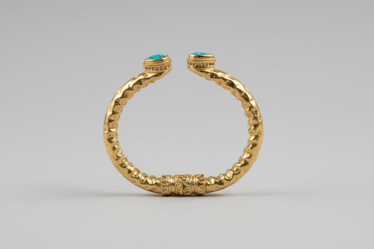 Bracciale etrusco a molla in bronzo con oro opaco e topazi azzurri naturali