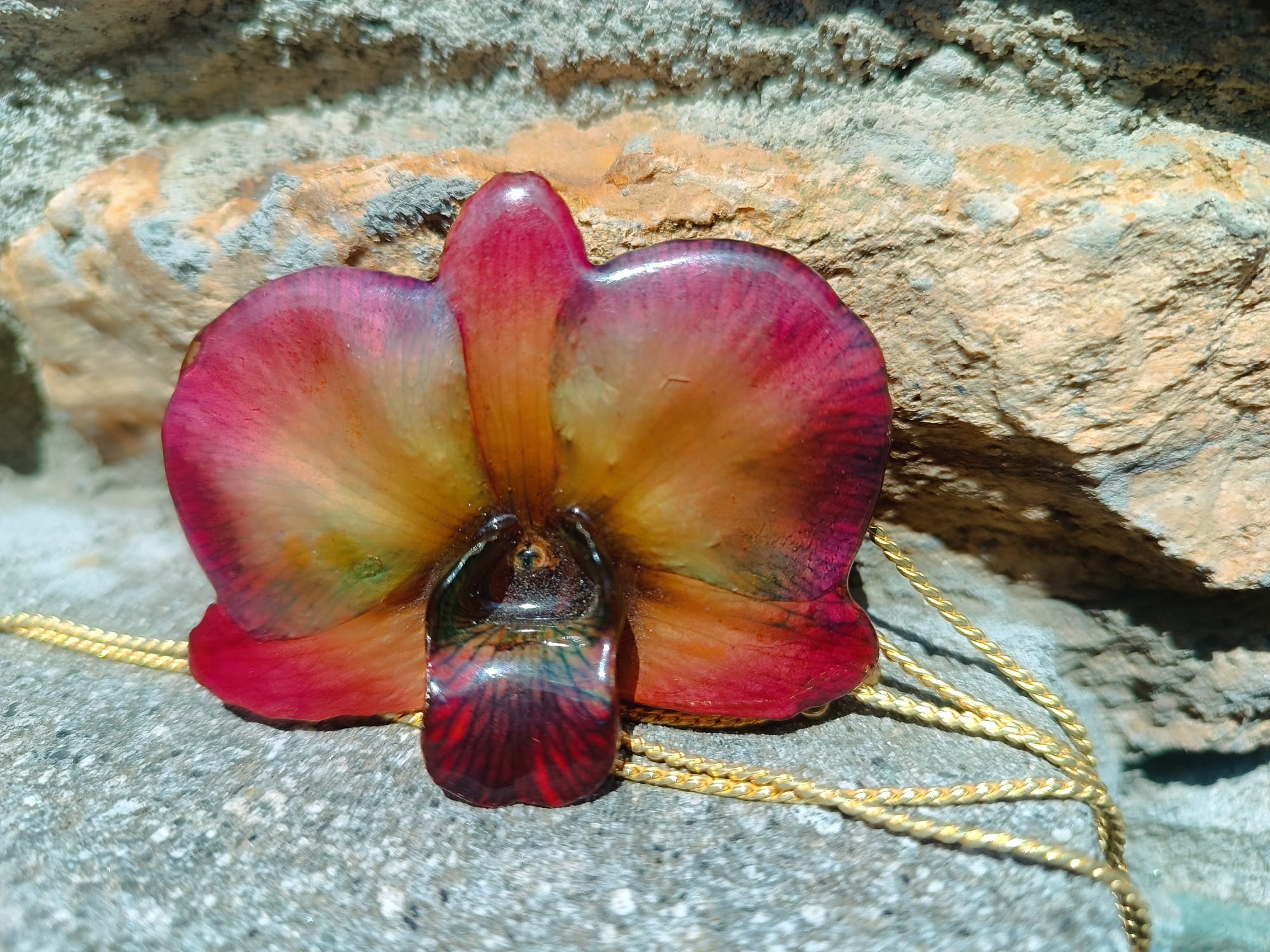 collana orchidea dendrobium marrone riflessi rossi azzurri resina saliscendi oro galvanizzato