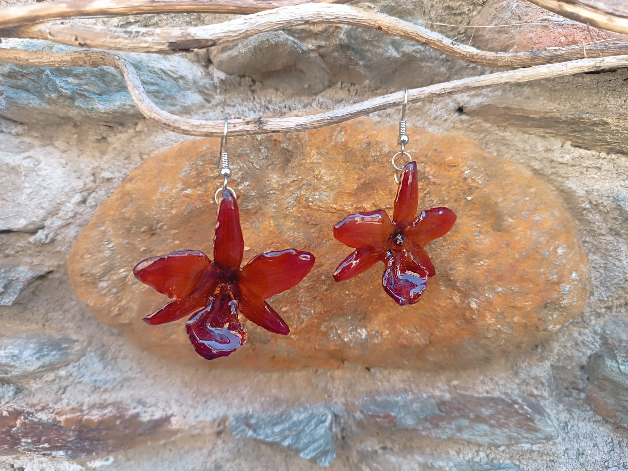 orecchini pendenti artigianali Rachele Falvo realizzati con intere orchidee vere sfumate in arancio ruggine, marrone terra di siena e bordeaux in resina lucida