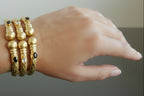 Tris di bracciali etruschi in oro opaco su bronzo con quarzi rosa e onici neri naturali